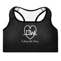 Front view of the Lord and Armor Taking the Wins sports bra in black, large TTW heartbeat cross heart with Taking the Wins in white script | Christian sports bra