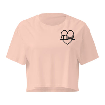 Taking the Wins heart crop top in Pale Pink, front with small TTW heart on left chest