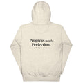 Back view of the Lord and Armor POP. pullover hoodie in Oatmeal Heather, Progress over Perfection. with Philippians 3:12 on the back in dark lettering